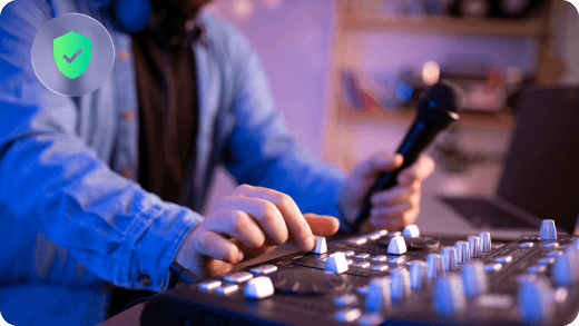 A music producer reviewing audio in a studio workspace