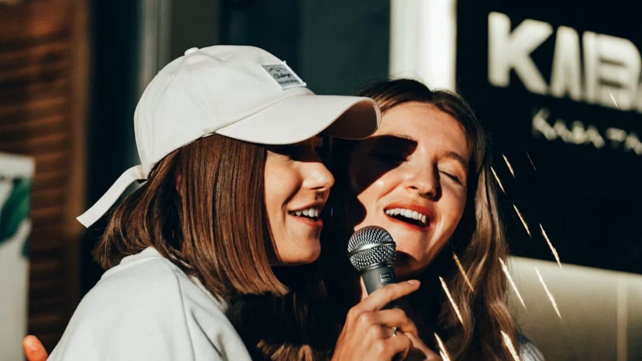 Two singers rehearsing together with a microphone